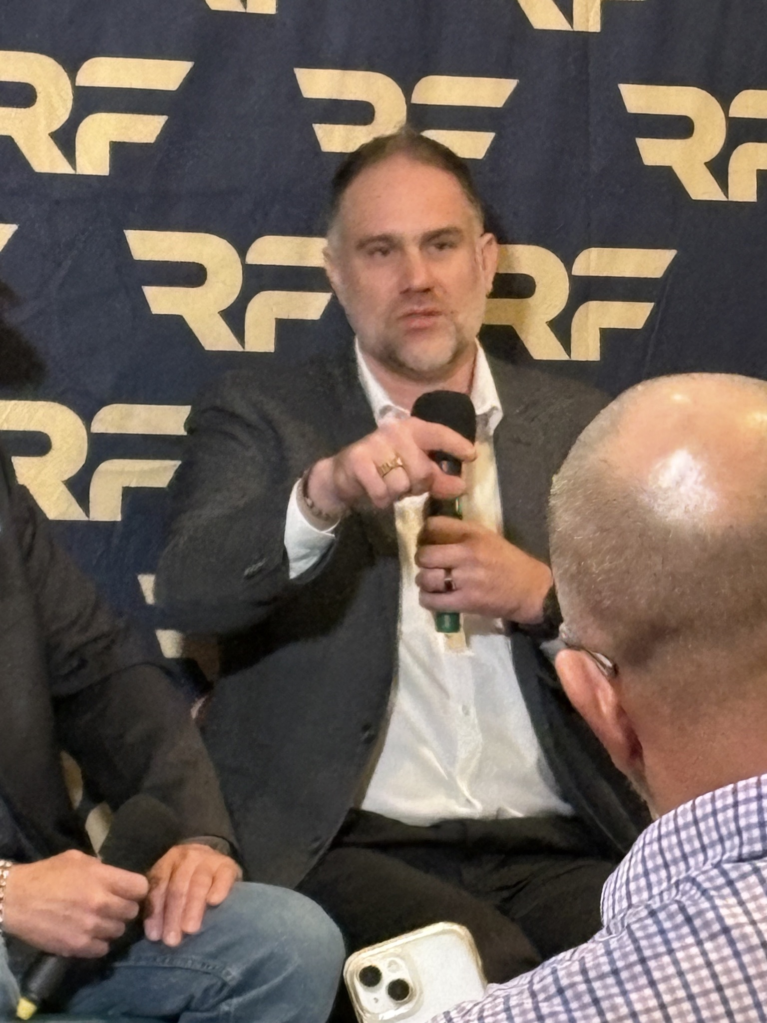 John Wingate speaking on a panel at an XRP event in Denver